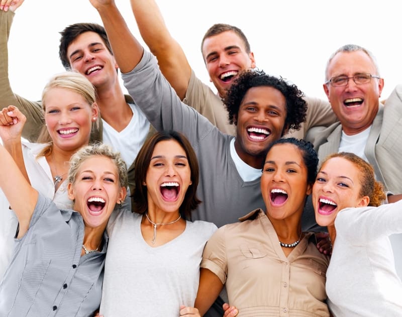 Portrait of a group of business people laughing against white ba
